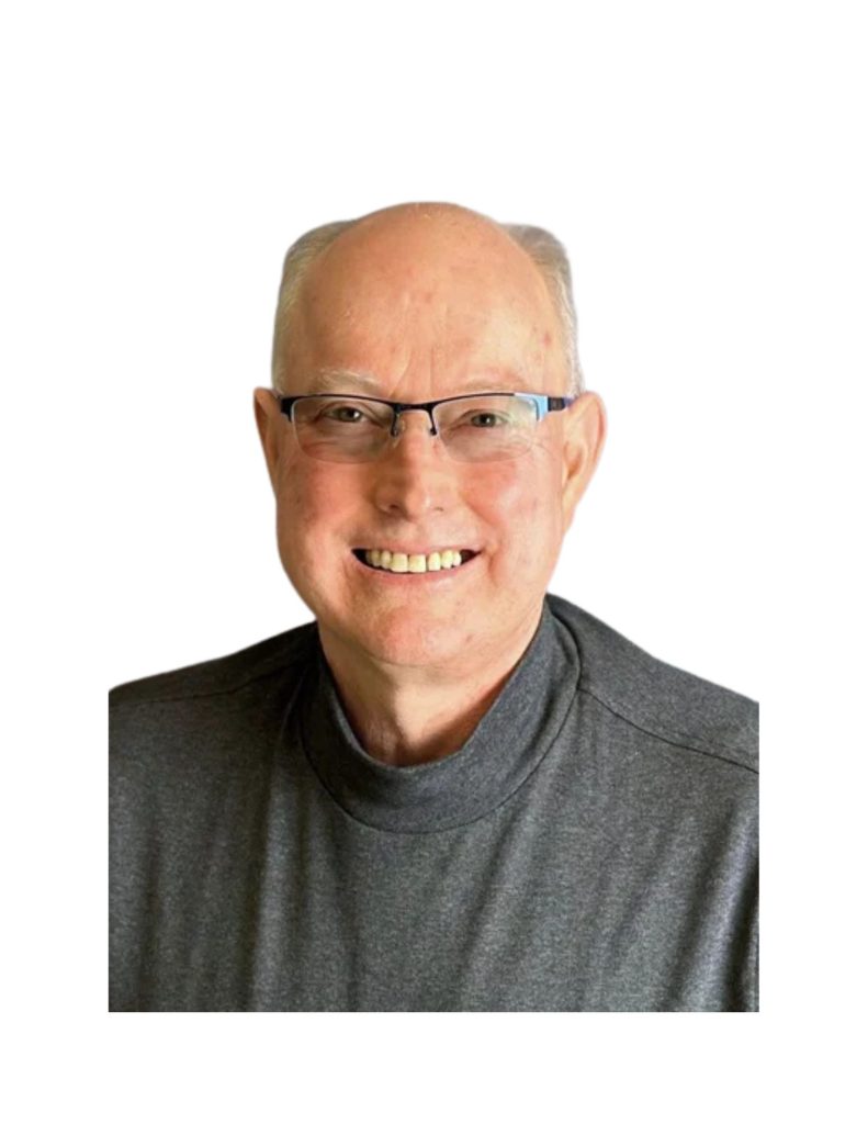 Smiling older man with glasses, cropped portrait against a white background, wearing a dark gray crewneck shirt.